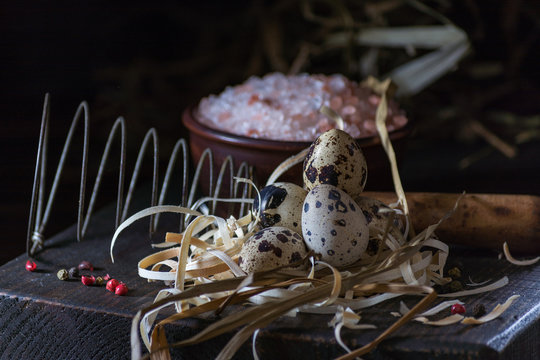 Decoration with qail eggs in nest. Breacfest prepearing process. Copy space. Farm style photo.