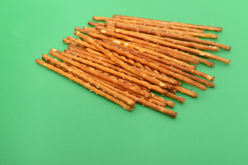 many salted sticks over a green background