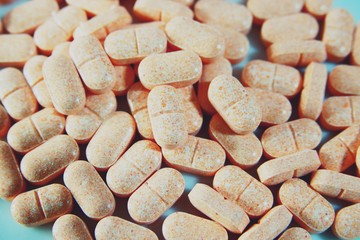 Pile of orange pills of vitamins