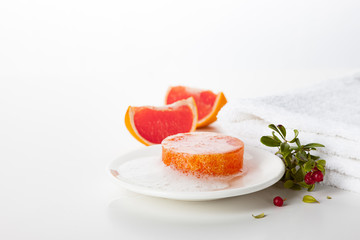 Handmade soap on a white background. Skin care product with the scent of grapefruit and wild berries. Spa treatments and aromatherapy for smooth and healthy skin.