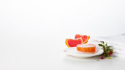 Natural handmade soap on a white background. Skin care product with the scent of grapefruit and wild berries. Spa treatments and aromatherapy for smooth and healthy skin.