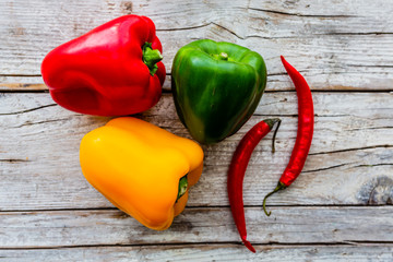 Raw colorful paprika on a wooden background.