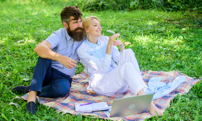 Family enjoy relax nature background. Couple bearded man and blonde woman relax nature while sit on...