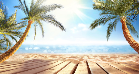 Summer  panoramic  landscape, nature of tropical beach with wooden platform, sunlight. Golden sand beach, palm trees, sea water against blue sky with white clouds. Copy space, summer vacation concept.