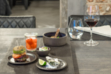 Laid table in the restaurant.  Blurred photo, backround.