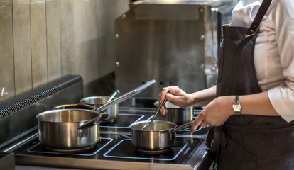 Cook works in the kitchen. Cooking food. Restaurant, chef.