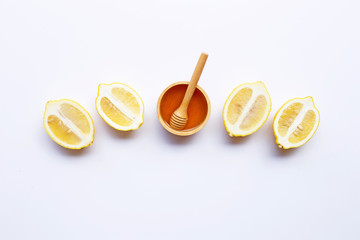 Honey with lemon on white background.