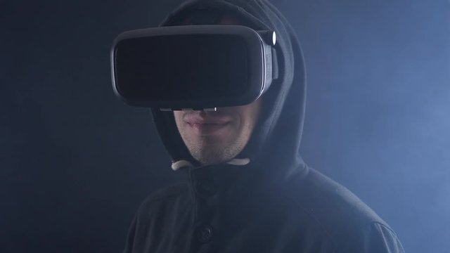 Futuristic world of global virtual reality. Close up portrait of man using virtual reality glasses.