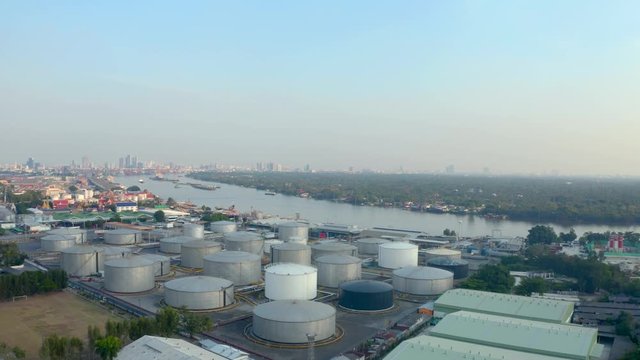 Aerial shot of large white industrial tank for fuel storage.Liquefied natural gas distribution station top view.LNG cisterns,oil terminal in Bangkok port.Transportation,logistics industry concept