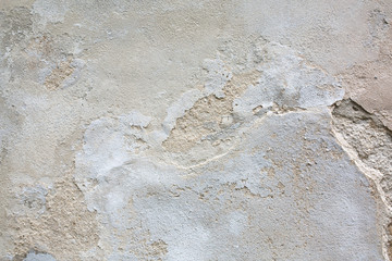 Outdoor shot of cracked grey cement wall