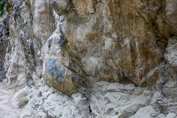 Huge massive natural textured stone wall with uneven surface. 