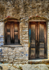 Stone house with wooden window and door in Symi island, Greece