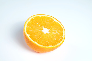 Close up image of juicy organic halved orange with visible core texture on isolated white background with a lot of copy space for text. Macro shot of bright citrus fruit. Top view.