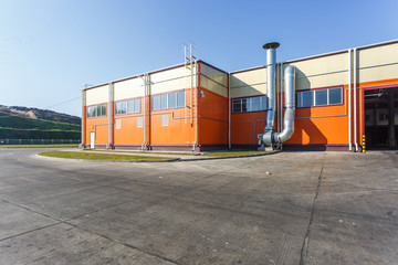 manufacture building of modern waste recycling processing plant in orange style. Separate garbage collection. Recycling and storage of waste for further disposal.