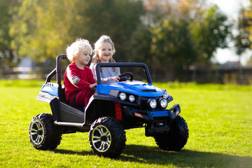 Kids driving electric toy car. Outdoor toys.