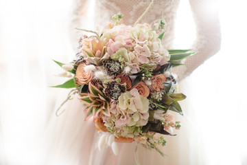 the bride holds a wedding bouquet