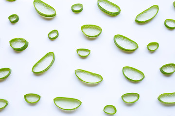 Aloe vera slices on white background.