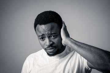 Close up portrait of Unhappy sad young man face suffering from depression and stress