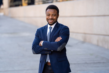 Half length portrait of an attractive stylish and successful businessman outside city street