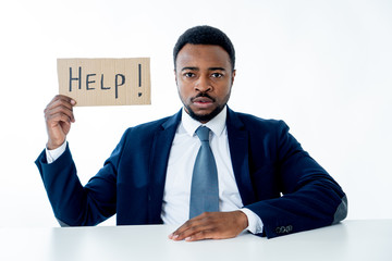Young Businessman Holding Cardboard With Help Text At Workplace in stress and pressure at work.