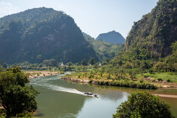Mountain landscape view with river boat and white pagodas