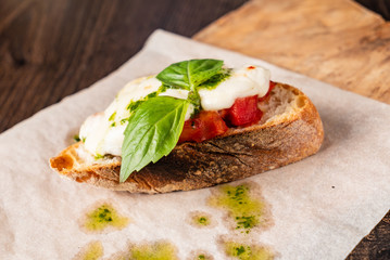 Traditional italian bruschetta with cherry tomatoes, cream cheese, basil leaves