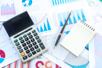Obraz premium Calculator with Business Graphs finance document.
