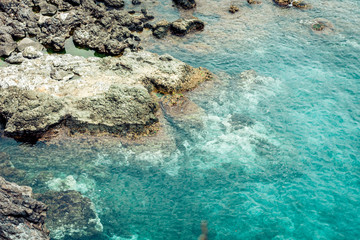 Rocky sea shore of Acitrezza next to Cyclops islands, Catania, Sicily, Italy.