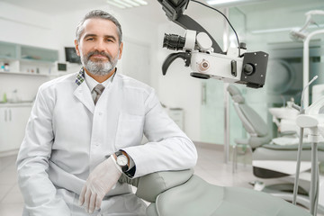 Professional male dentist looking at camera and smiling