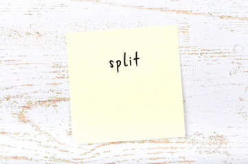 Yellow sticky note with handwritten text split