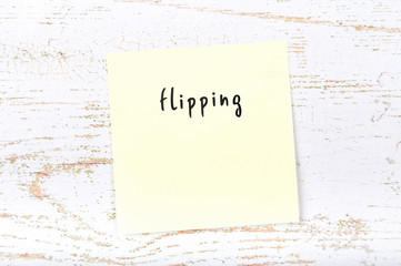 Yellow sticky note with handwritten text flipping