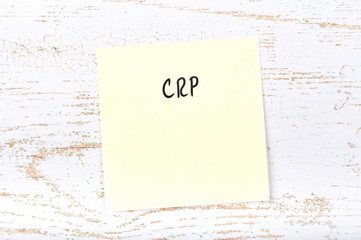 Yellow sticky note with handwritten text crp
