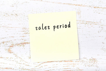 Yellow sticky note with handwritten text sales period