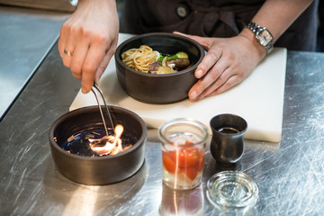 Cooking in the kitchen. Chef. A restaurant.
Open fire.