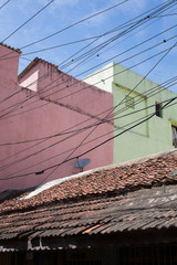 Chennai / India - February 2018: Cables in front of colorful houses.