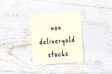 Yellow sticky note with handwritten text non deliveryold stocks