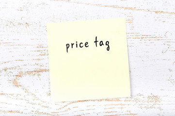 Yellow sticky note with handwritten text price tag