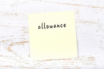 Yellow sticky note with handwritten text allowance