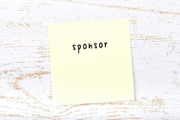 Yellow sticky note with handwritten text sponsor