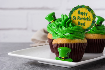 St. Patrick's Day cupcakes on gray background. Copyspace