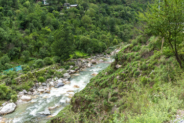 Fototapeta na wymiar Lush green beautiful Tirthan valley. This quiet valley is ideal for trekking, fishing, wildlife watching, and discovering under-explored hill villages.