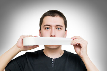 a young man taped his mouth shut with duct tape, a man with his mouth taped. the concept of...