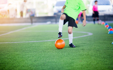boy soccer player trap and control football between cone makers © Koonsiri