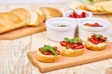 Bruschetta or crostini with sun dried tomatoes and capers