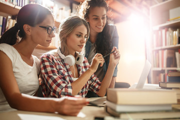 In the tranquil morning hours, a diligent group of female students assembles in the college library, gearing up for a productive day of focused studying and preparation.