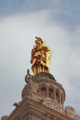 Virgin Mary statue with child on cathedral bell tower. Marseille, France