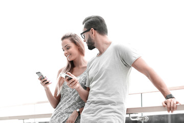 young couple reading text message on smartphone