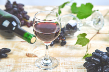 Red wine concept with bottle, glass and grapes