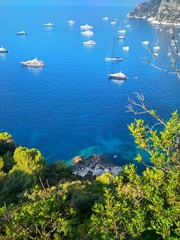 Blue sea with yachts and sky and coast with green