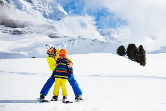Family skiing in mountains. Mother and kid ski.